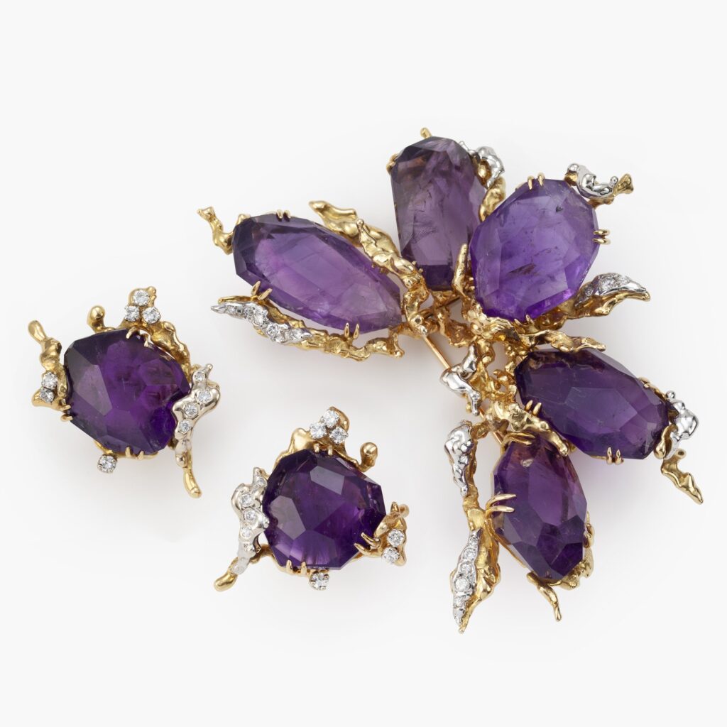 An eighteen carat yellow and white gold brooch with matching clip earrings, set with amethysts and diamonds. Signed Pierre Sterlé Paris, made ca 1970.