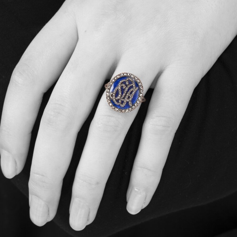 An antique rose gold and silver ring with blue enamel and diamonds, made ca 1880