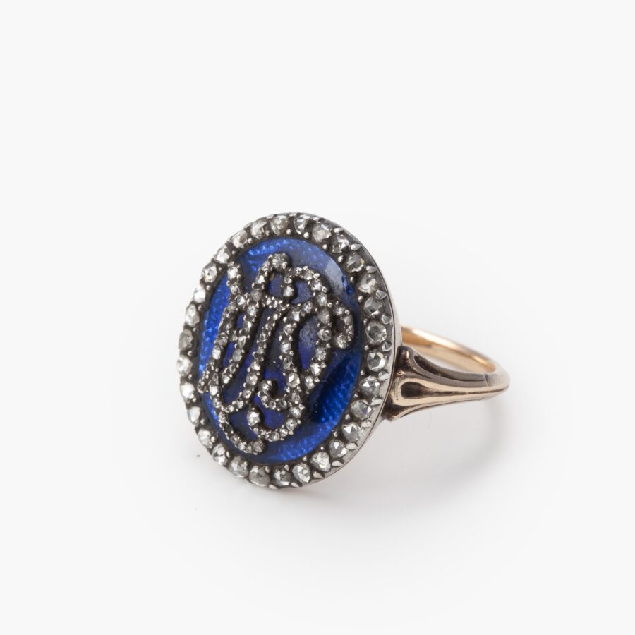An antique rose gold and silver ring with blue enamel and diamonds, made ca 1880