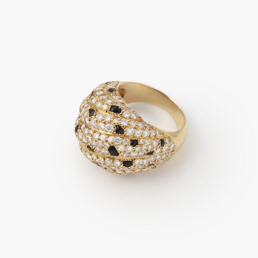 An eighteen carat yellow gold ring, pavé set with diamonds and onyx. Signed Cartier Paris, made ca 1995 and numbered.