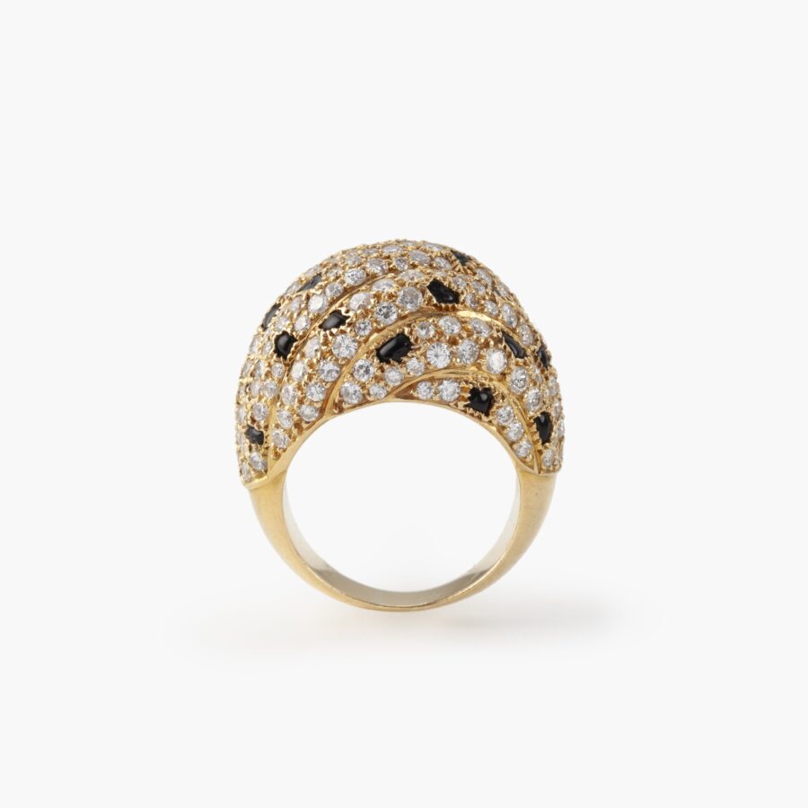 An eighteen carat yellow gold ring, pavé set with diamonds and onyx. Signed Cartier Paris, made ca 1995 and numbered.