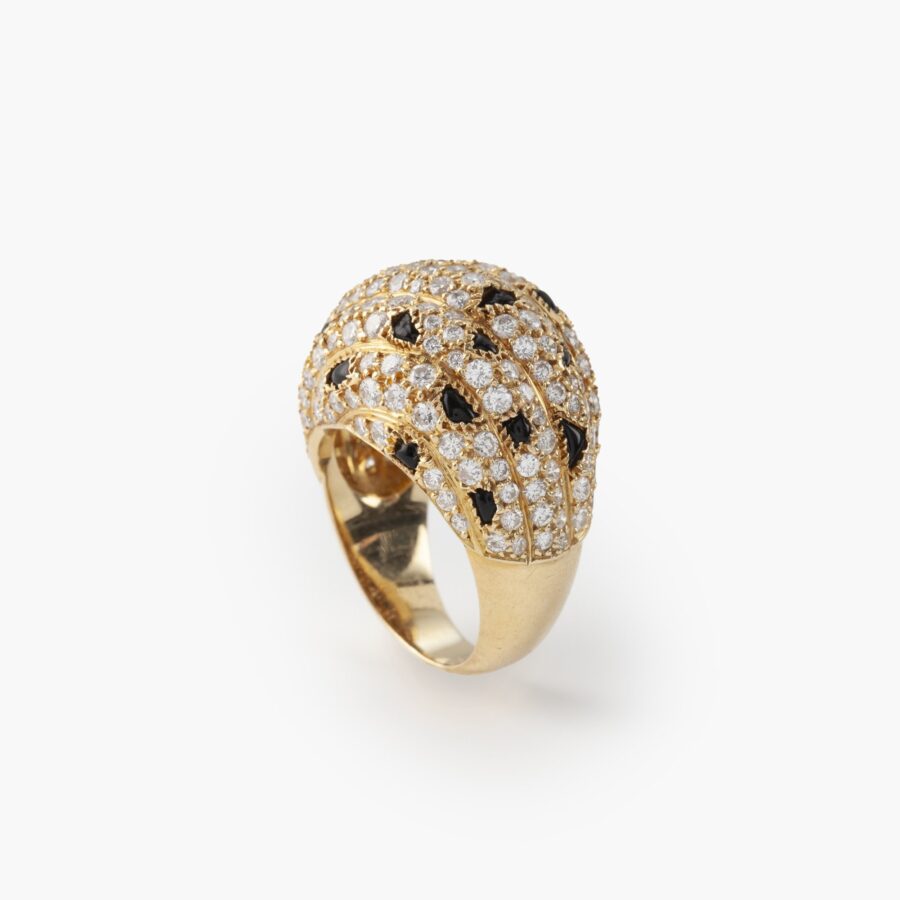 An eighteen carat yellow gold ring, pavé set with diamonds and onyx. Signed Cartier Paris, made ca 1995 and numbered.