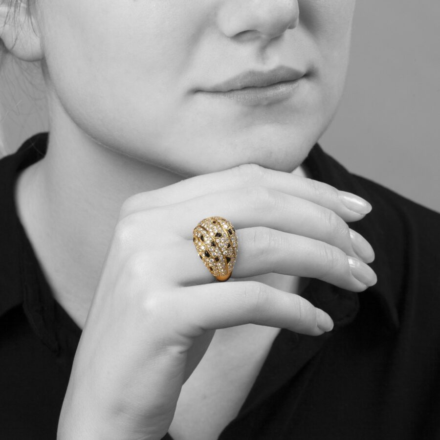 An eighteen carat yellow gold ring, pavé set with diamonds and onyx. Signed Cartier Paris, made ca 1995 and numbered.