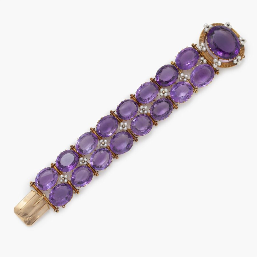 An antique eighteen carat pinkish gold bracelet set with oval facetted amethysts and clusters of pearls, on a large oval catch lock, made ca 1870.