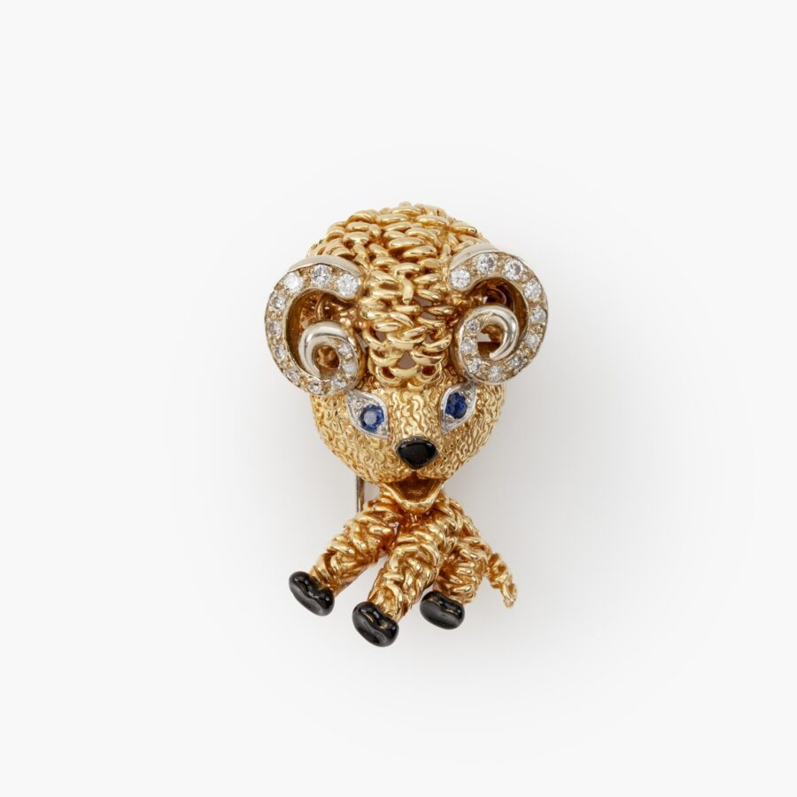An eighteen carat yellow gold brooch designed as a ram, set with diamonds, sapphires and with black enamel. Signed Van Cleef & Arpels, Paris and dated 1963.