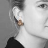A pair of eighteen carat gold earclips model ‘Pelouse Hawaii’, set with diamonds, rubies and sapphires. Signed Van Cleef & Arpels, made ca 1950.