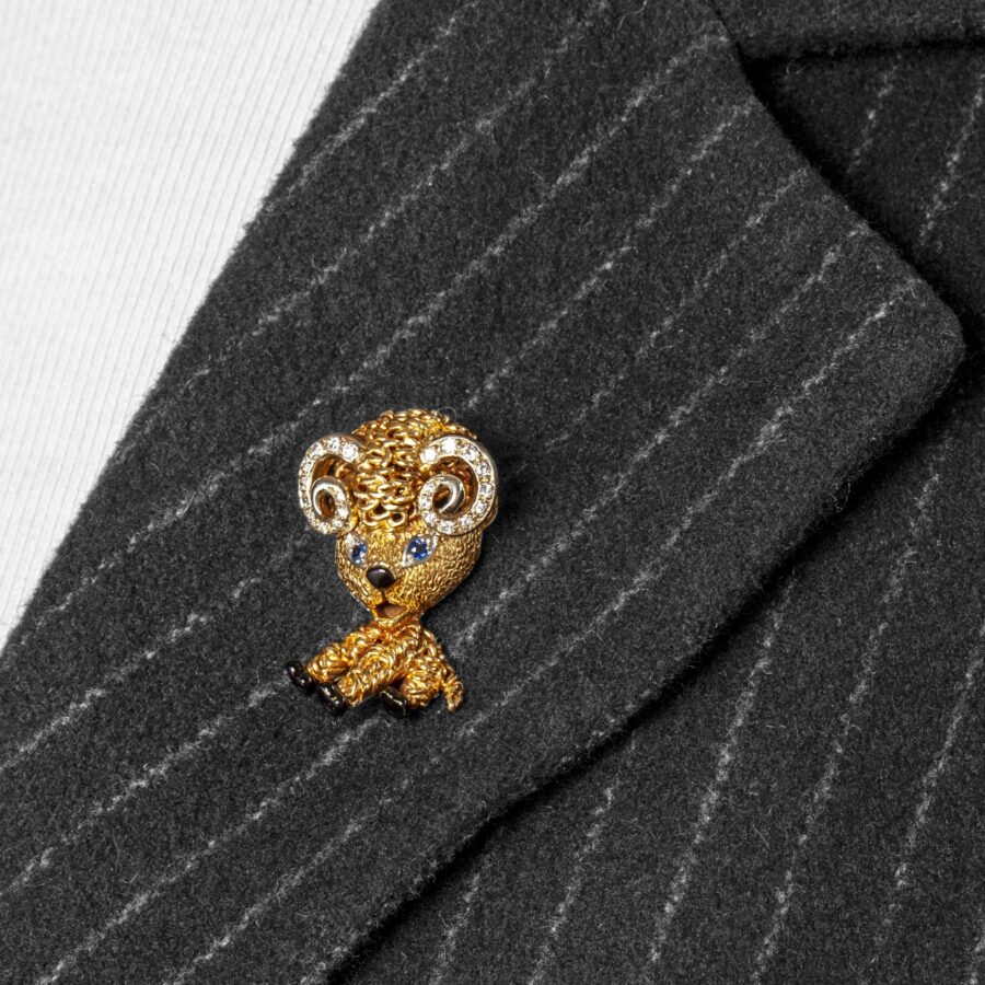 An eighteen carat yellow gold brooch designed as a ram, set with diamonds, sapphires and with black enamel. Signed Van Cleef & Arpels, Paris and dated 1963.