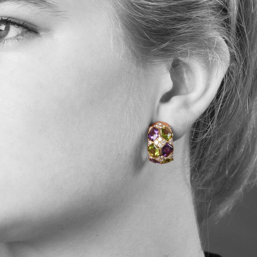 A pair of eighteen carat yellow gold clip earrings with matching ring, set with diamonds, amethysts and peridots. Van Cleef & Arpels, Paris, ca 1990. 