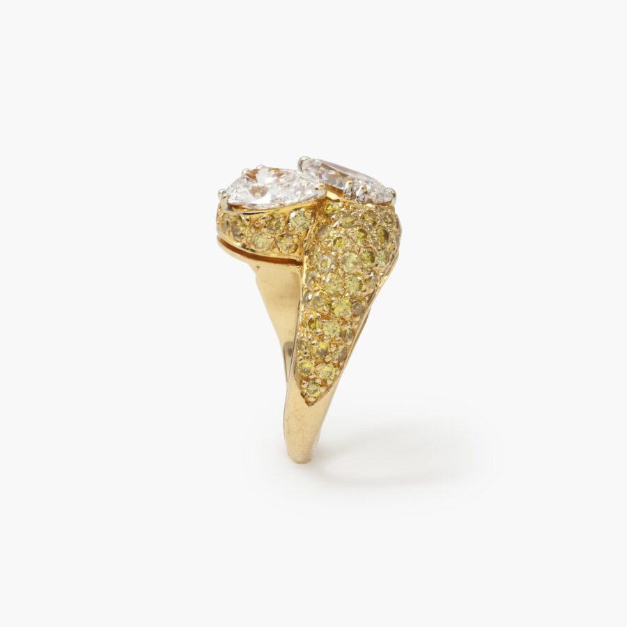 An eighteen carat yellow gold cross over ring ‘Toi et Moi’ set with two pear shaped diamonds and  many yellow diamonds. Made by Graff and numbered.