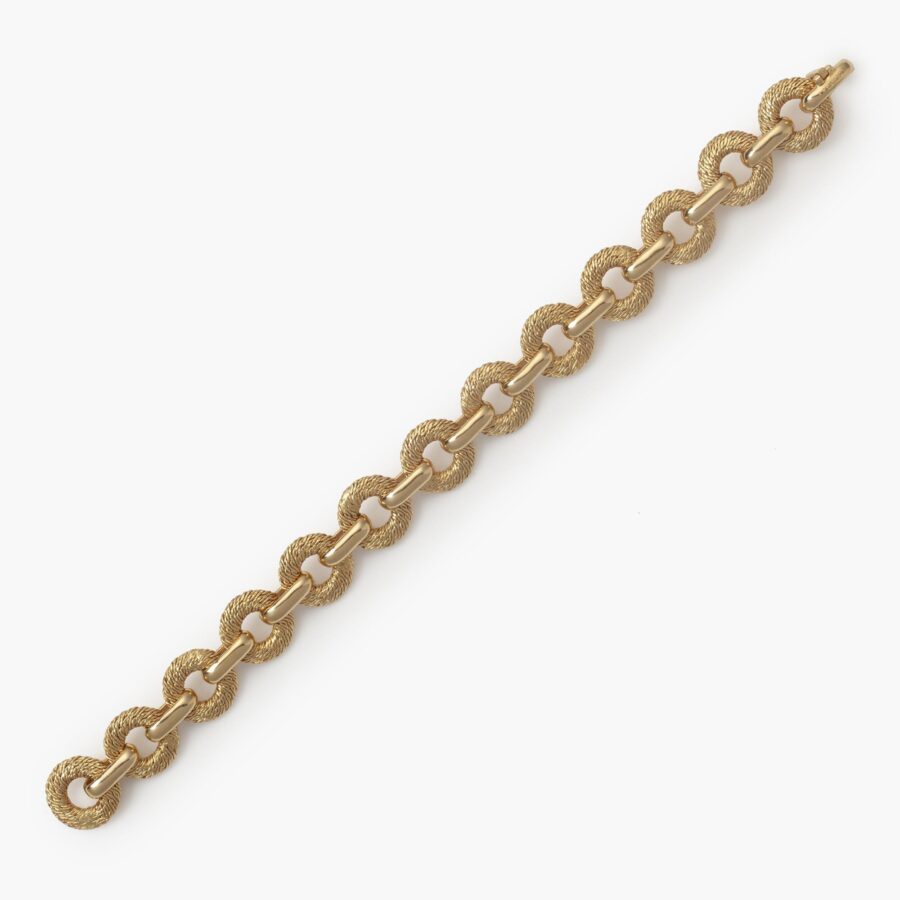 An eighteen carat yellow bracelet made of woven from goldwire flat circular links. Signed Fred, Paris, made by Georges Lenfant, Paris, ca 1970.
