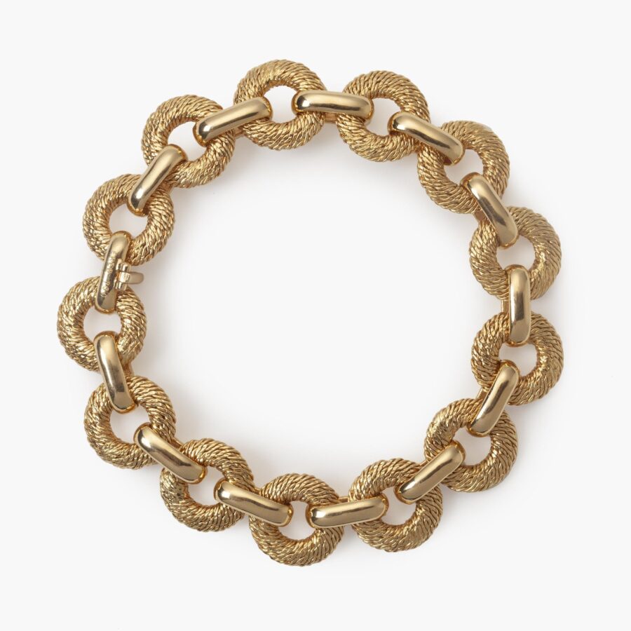 An eighteen carat yellow bracelet made of woven from goldwire flat circular links. Signed Fred, Paris, made by Georges Lenfant, Paris, ca 1970.