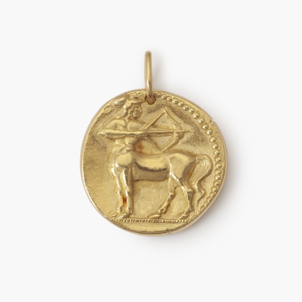 An eighteen carat yellow gold round pendant with the zodiac sign sagittarius. Signed Van Cleef & Arpels, Paris, ca 1970. Made byf Georges Lenfant, Paris.