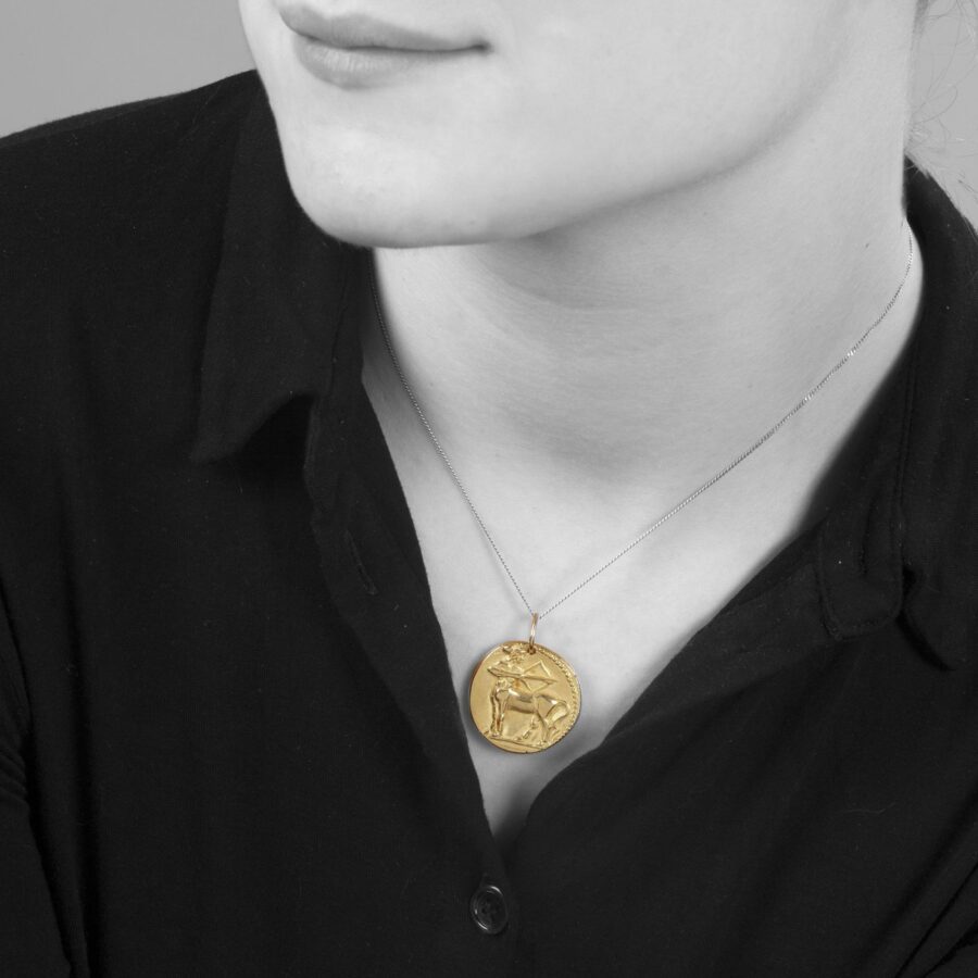 An eighteen carat yellow gold round pendant with the zodiac sign sagittarius. Signed Van Cleef & Arpels, Paris, ca 1970. Made byf Georges Lenfant, Paris.