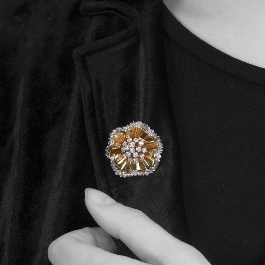 An eighteen carat yellow gold an platinum brooch designed as a rosette set with diamonds. Signed Van Cleef & Arpels and numbered. Made in Paris in 1947.