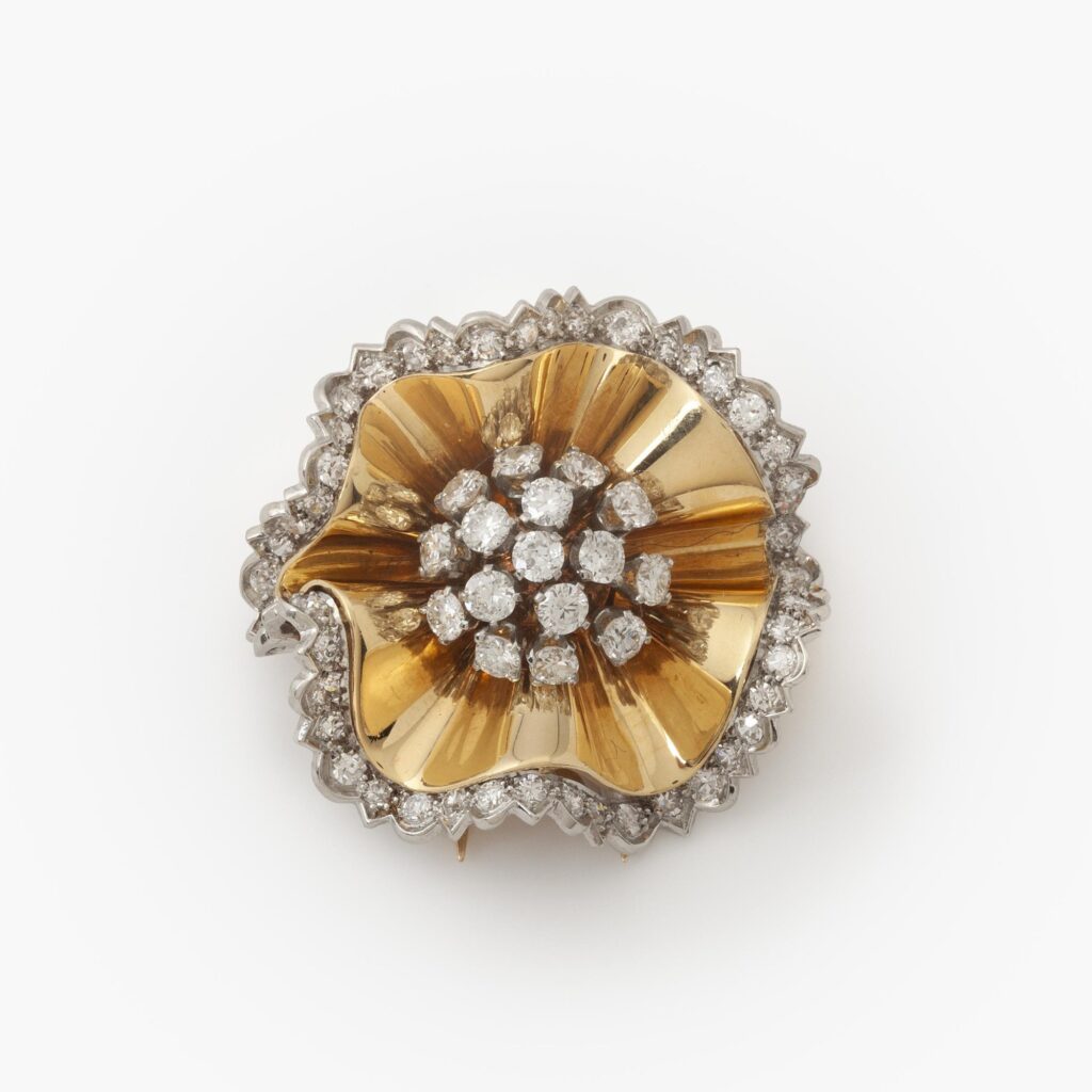 An eighteen carat yellow gold an platinum brooch designed as a rosette set with diamonds. Signed Van Cleef & Arpels and numbered. Made in Paris in 1947.