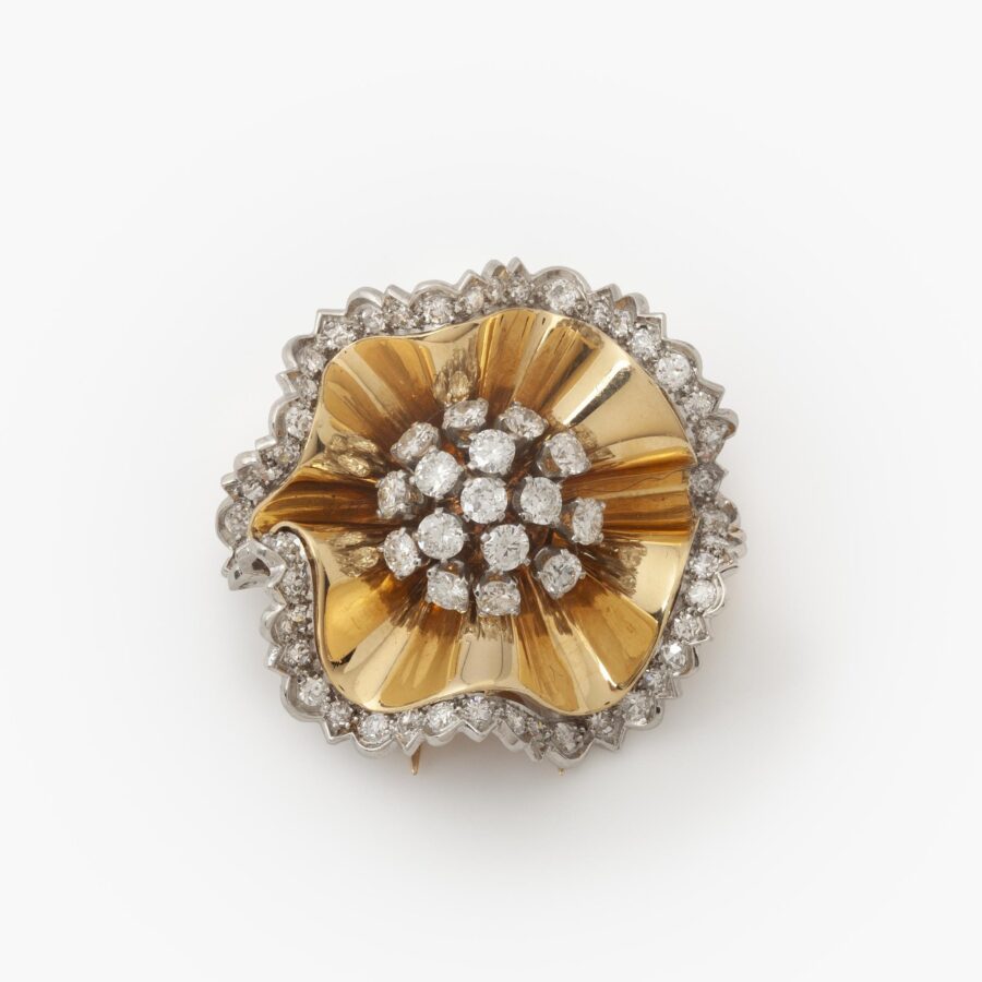 An eighteen carat yellow gold an platinum brooch designed as a rosette set with diamonds. Signed Van Cleef & Arpels and numbered. Made in Paris in 1947.
