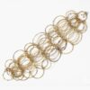 An eighteen carat yellow gold necklace with matching bracelet consisting of many strings of irregular round links. Signed Cartier, numbered. Made ca 1980.