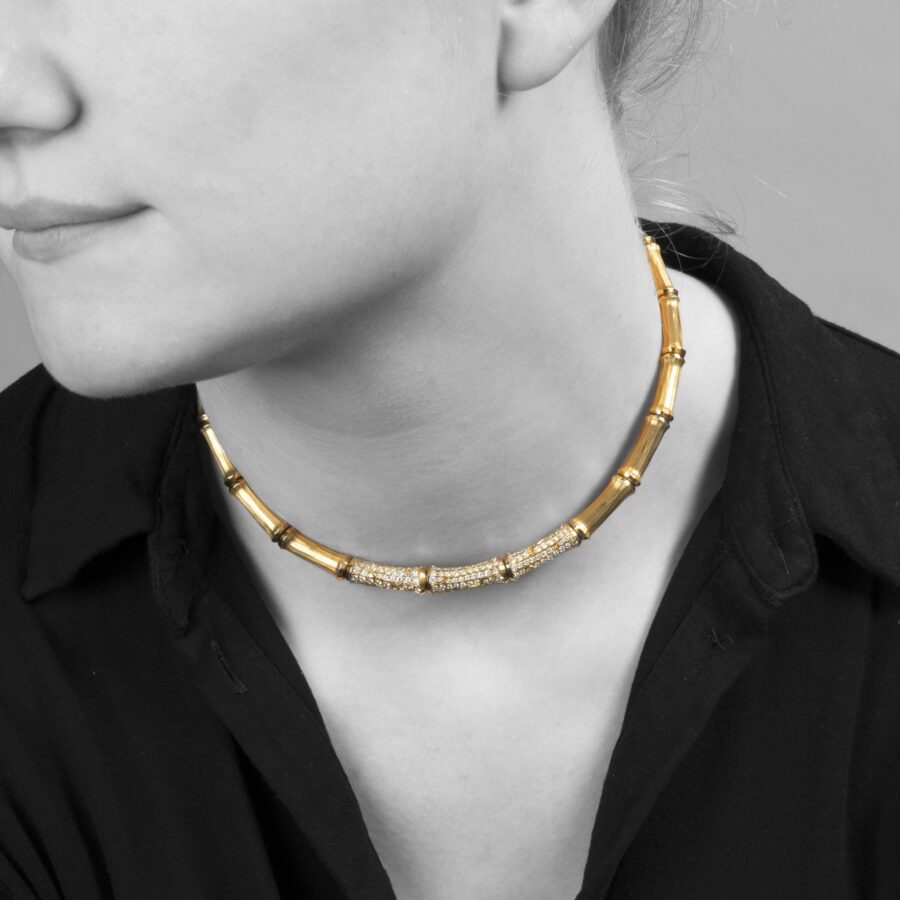 An eighteen carat yellow gold ´Bamboo´ necklace, the central three segments pavé set with brilliant cut diamonds. Signed Cartier and numbered.