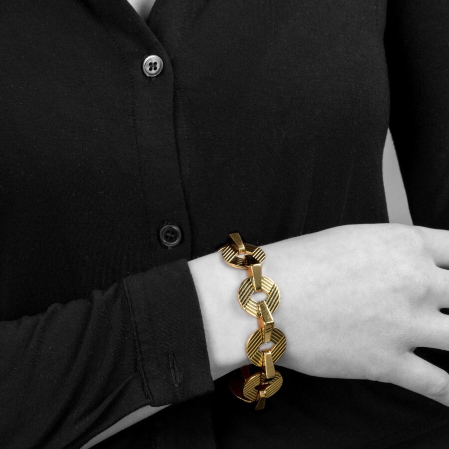 An eighteen carat yellow gold bracelet made of eight round and eight triangular links. Signed Cartier, London and numbered. Dated 1959.