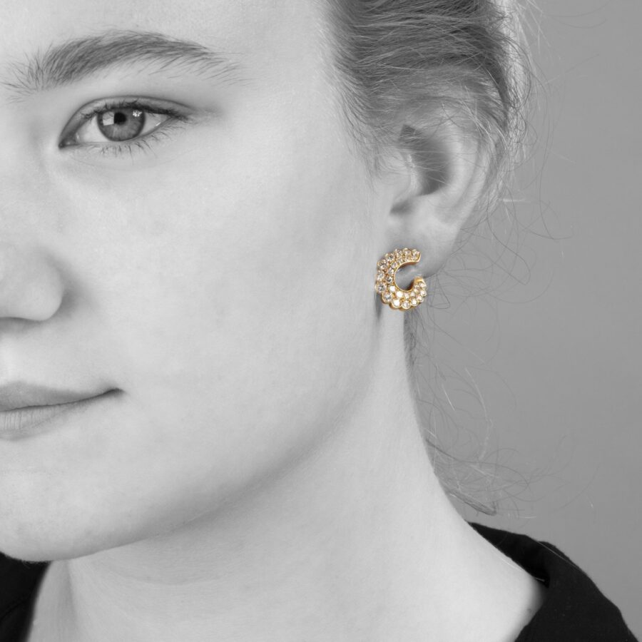 A pair of eighteen carat yellow gold clip earrings pavé set with brilliant cut diamonds. Signed Van Cleef & Arpels and numbered, made in Paris, around 1980. 