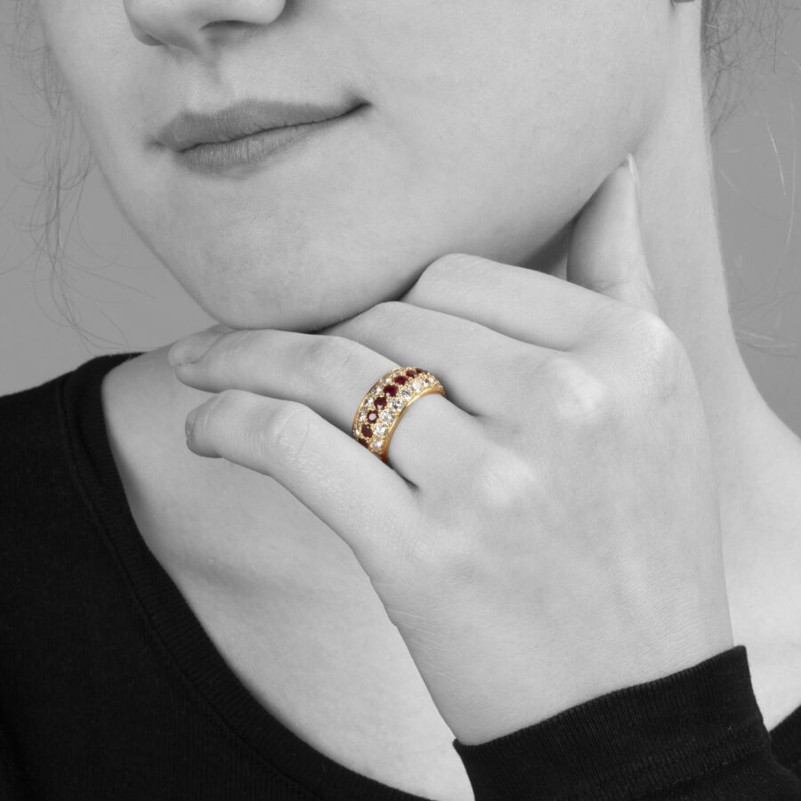 An eighteen carat yellow gold eternity ring, all around pavé set rubies and diamonds. Signed Van Cleef & Arpels, Paris. With original case and pouch.