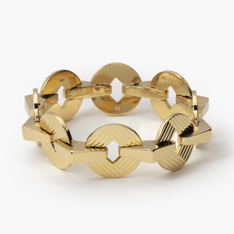 An eighteen carat yellow gold bracelet made of eight round and eight triangular links. Signed Cartier, London and numbered. Dated 1959.