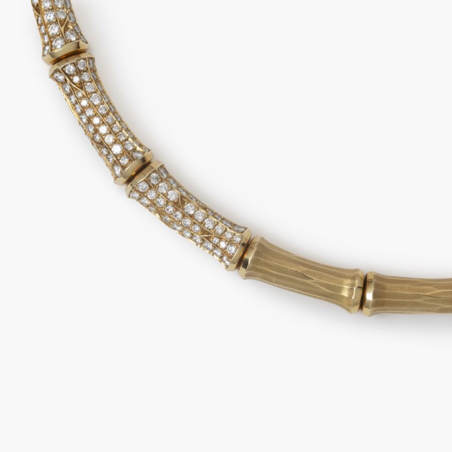 An eighteen carat yellow gold ´Bamboo´ necklace, the central three segments pavé set with brilliant cut diamonds. Signed Cartier and numbered.