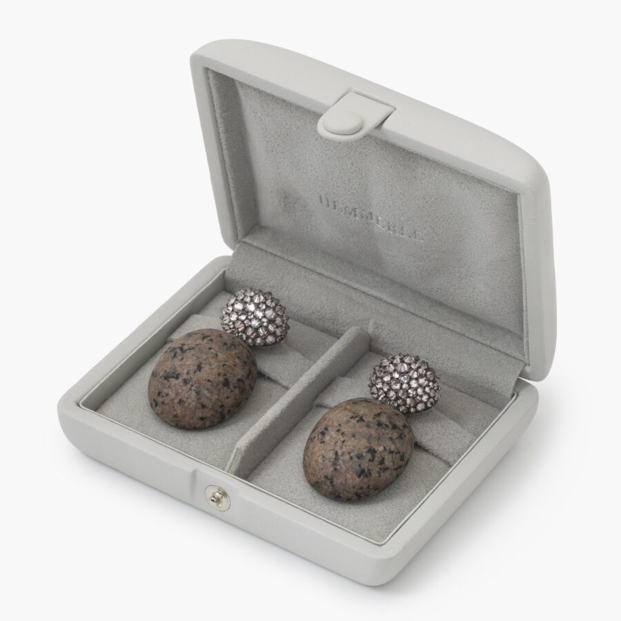 A pair of eighteen carat white gold and silver earrings set with very light pink diamonds and pink granite. Signed Hemmerle, Munich. In original case.