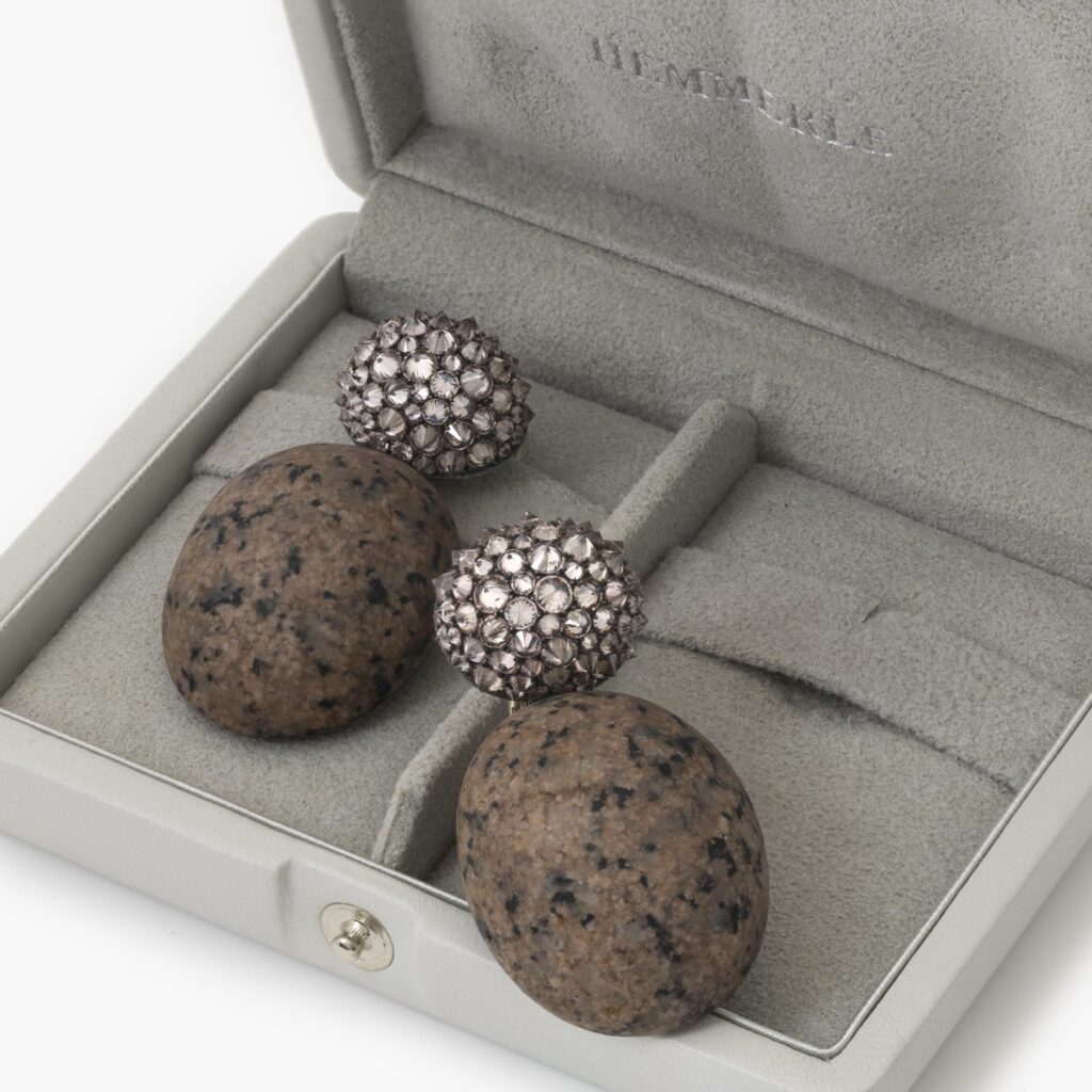 A pair of eighteen carat white gold and silver earrings set with very light pink diamonds and pink granite. Signed Hemmerle, Munich. In original case.