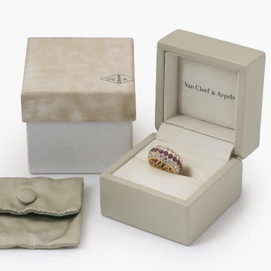 An eighteen carat yellow gold eternity ring, all around pavé set rubies and diamonds. Signed Van Cleef & Arpels, Paris. With original case and pouch.