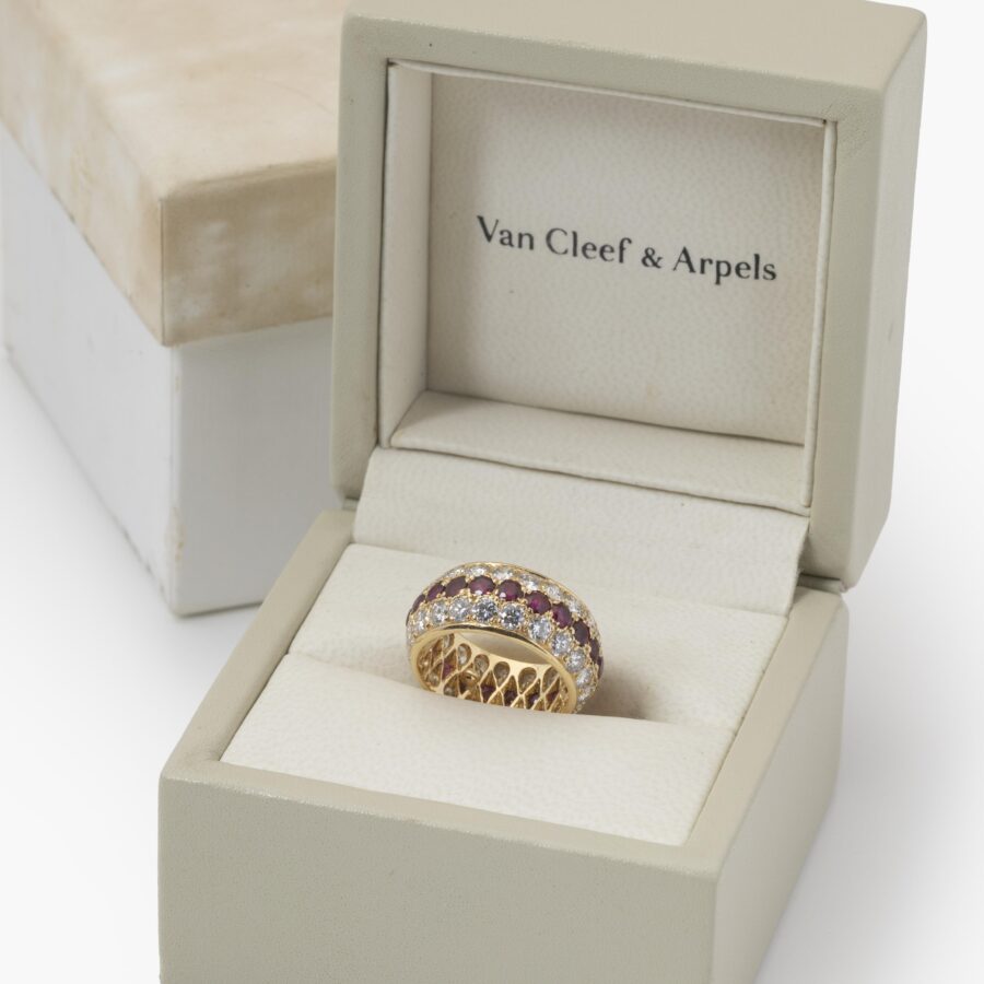 An eighteen carat yellow gold eternity ring, all around pavé set rubies and diamonds. Signed Van Cleef & Arpels, Paris. With original case and pouch.