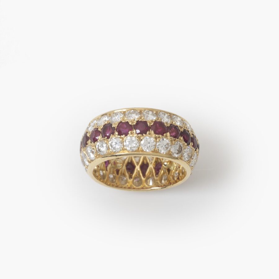 An eighteen carat yellow gold eternity ring, all around pavé set rubies and diamonds. Signed Van Cleef & Arpels, Paris. With original case and pouch.