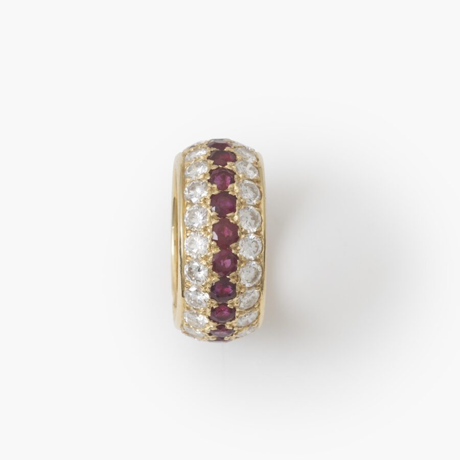 An eighteen carat yellow gold eternity ring, all around pavé set rubies and diamonds. Signed Van Cleef & Arpels, Paris. With original case and pouch.