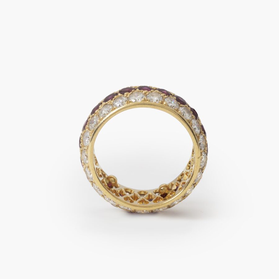 An eighteen carat yellow gold eternity ring, all around pavé set rubies and diamonds. Signed Van Cleef & Arpels, Paris. With original case and pouch.