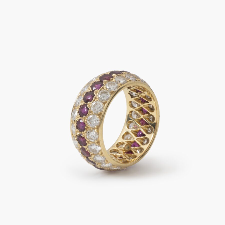 An eighteen carat yellow gold eternity ring, all around pavé set rubies and diamonds. Signed Van Cleef & Arpels, Paris. With original case and pouch.