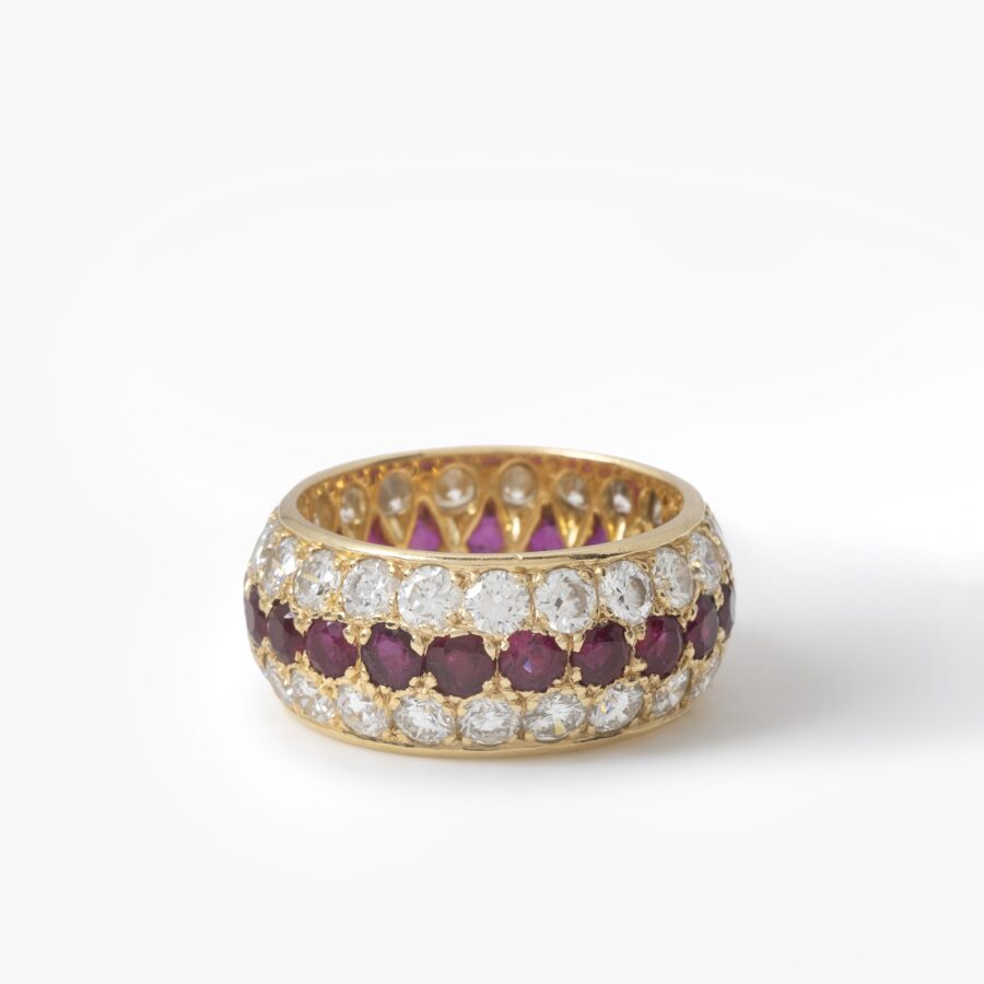 An eighteen carat yellow gold eternity ring, all around pavé set rubies and diamonds. Signed Van Cleef & Arpels, Paris. With original case and pouch.