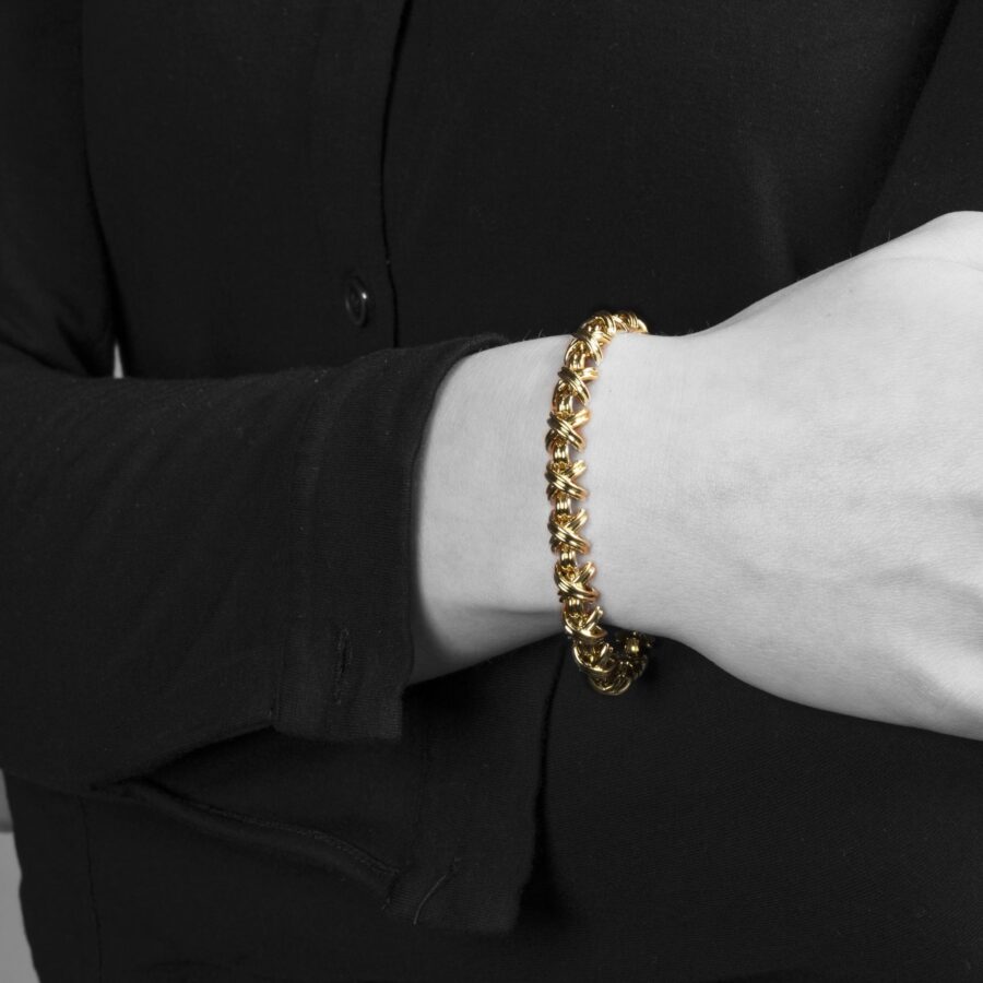 An eightteen carat yellow gold bracelet “Signature X” comprising nineteen x-shaped links, interconnected by bridge-shaped links, with box clasp with safety guard. After a design by Jean Schlumberger. Signed Tiffany & Co., USA.