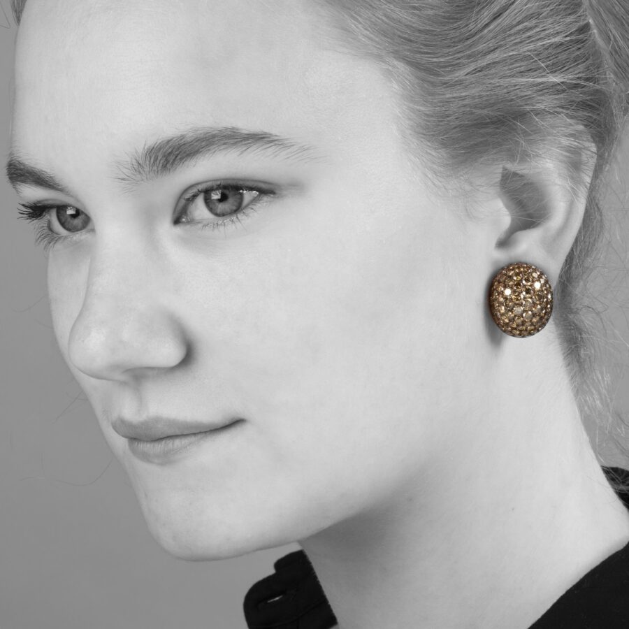 A pair of eighteen carat red gold and copper oval bombé clip earrings, pavé set with brilliant cut brown diamonds. Signed Hemmerle, made in Munich.