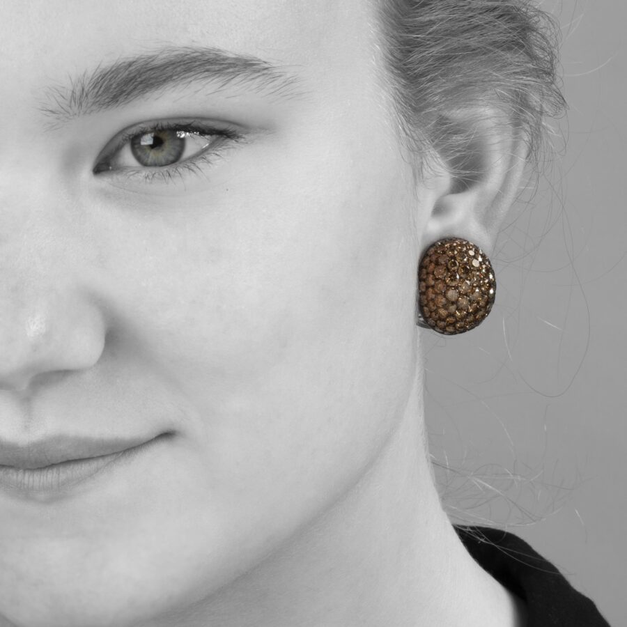 A pair of eighteen carat red gold and copper oval bombé clip earrings, pavé set with brilliant cut brown diamonds. Signed Hemmerle, made in Munich.
