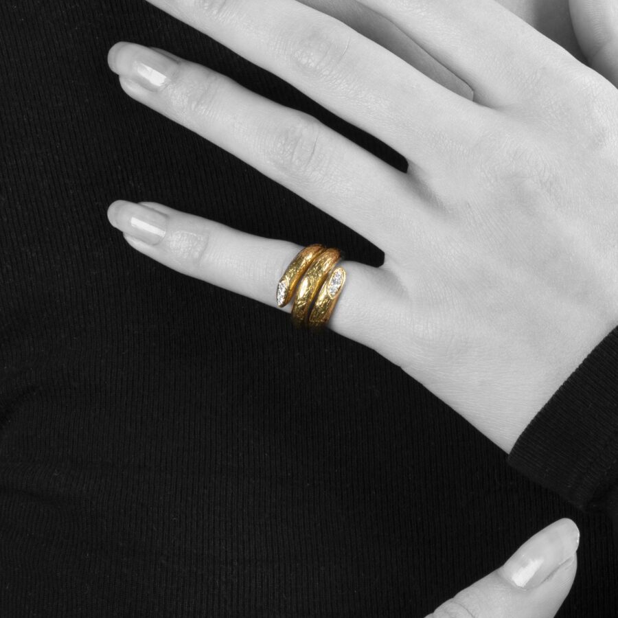 An eighteen carat yellow gold ring designed as two windings, with a textured surface. Signed Van Cleef & Arpels, made in Paris, made ca 1970 and numbered.