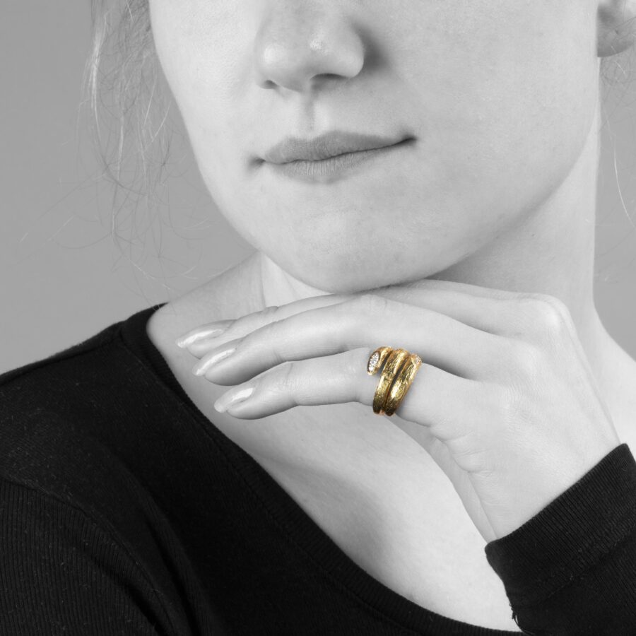 An eighteen carat yellow gold ring designed as two windings, with a textured surface. Signed Van Cleef & Arpels, made in Paris, made ca 1970 and numbered.