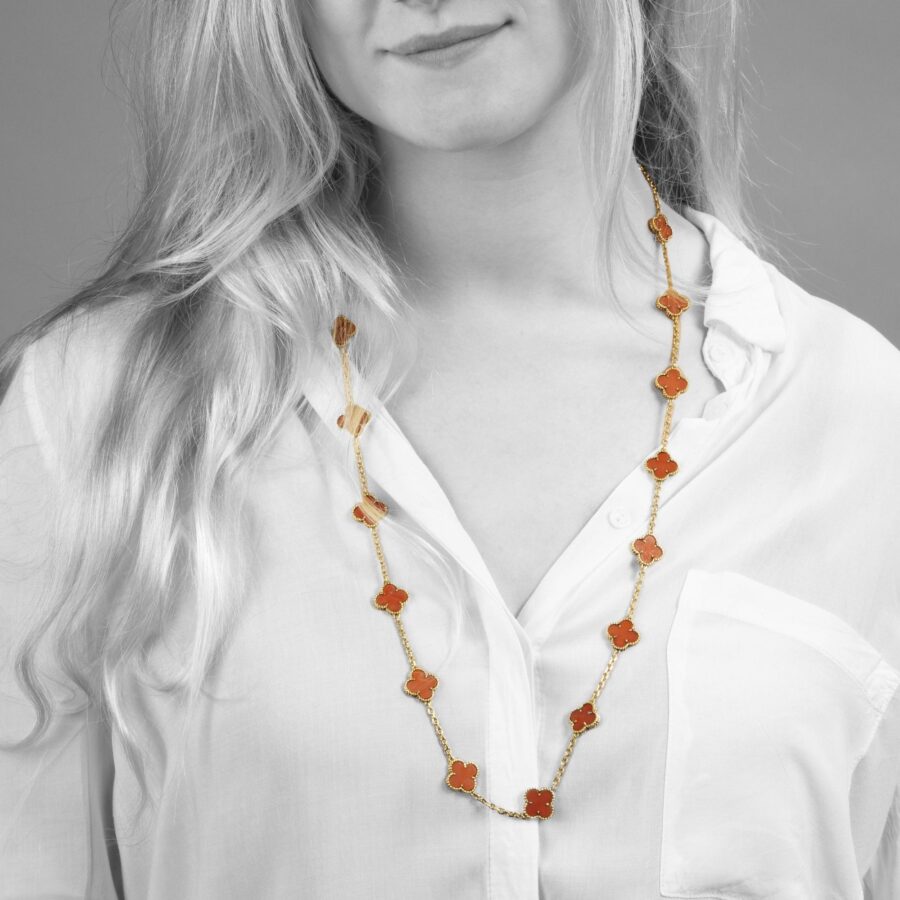 An eighteen carat yellow gold “Alhambra” longchain made of twenty coral “Alhambra” motifs. Signed Van Cleef & Arpels and numbered, made in Paris in 1977.