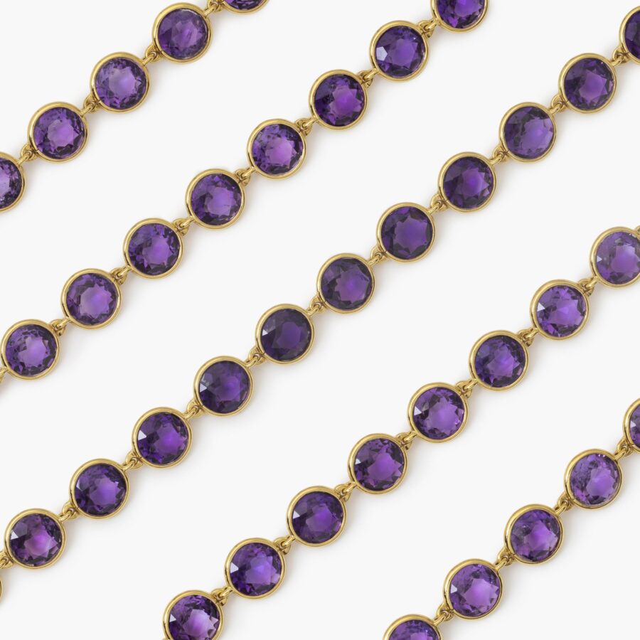 An eighteen carat yellow gold longchain designed as 80 round facetted amethysts in spectacle-mounts. Signed Van Cleef & Arpels, France, made in 1983. 