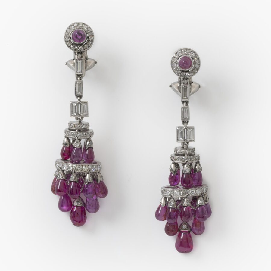 A pair of platinum Art Deco earrings, each mounted with plain drops of rubies and set with diamonds in various cuts, made ca 1920.