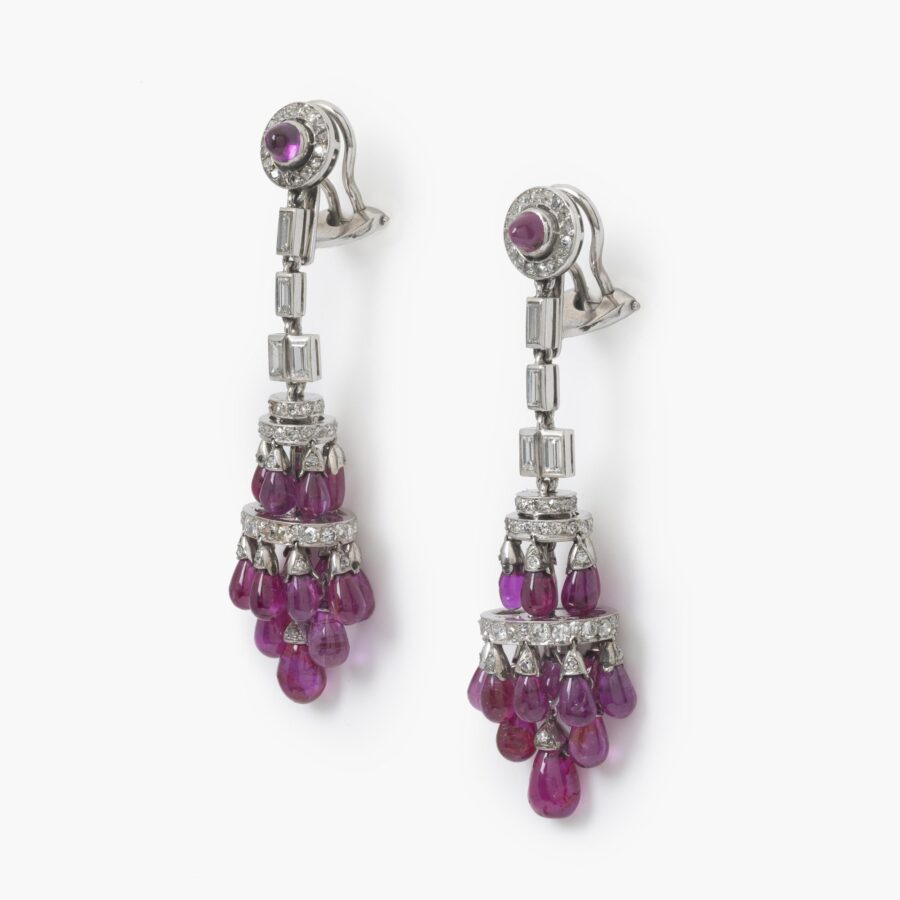 A pair of platinum Art Deco earrings, each mounted with plain drops of rubies and set with diamonds in various cuts, made ca 1920.