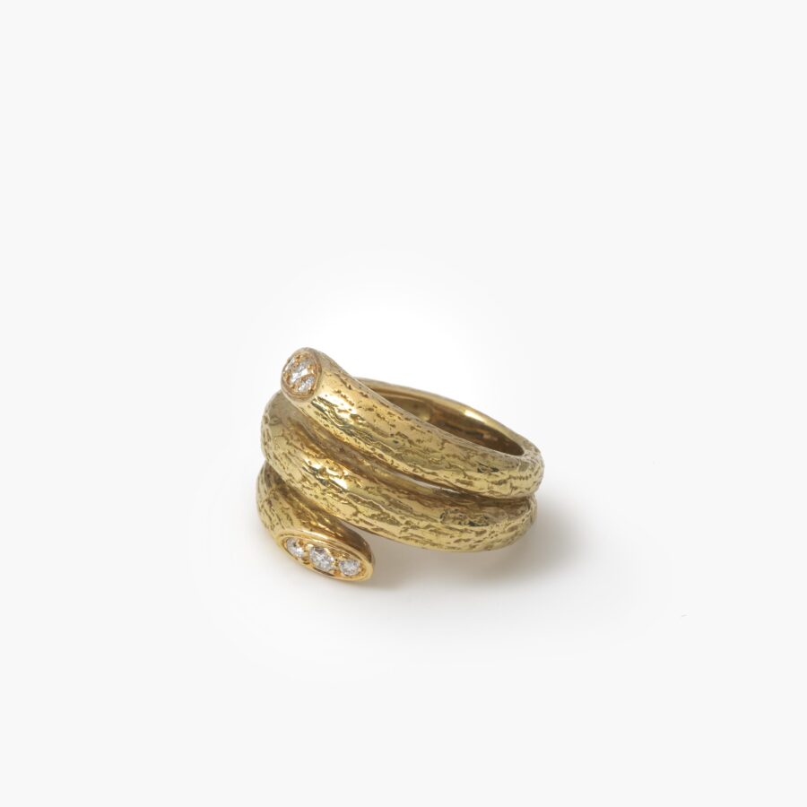 An eighteen carat yellow gold ring designed as two windings, with a textured surface. Signed Van Cleef & Arpels, made in Paris, made ca 1970 and numbered.