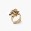 A fourteen carat yellow gold kinetic ring designed as two rotating open squares, each with one diamond. Signed N. Teufel, USA, dated 1972.
