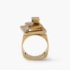A fourteen carat yellow gold kinetic ring designed as two rotating open squares, each with one diamond. Signed N. Teufel, USA, dated 1972.
