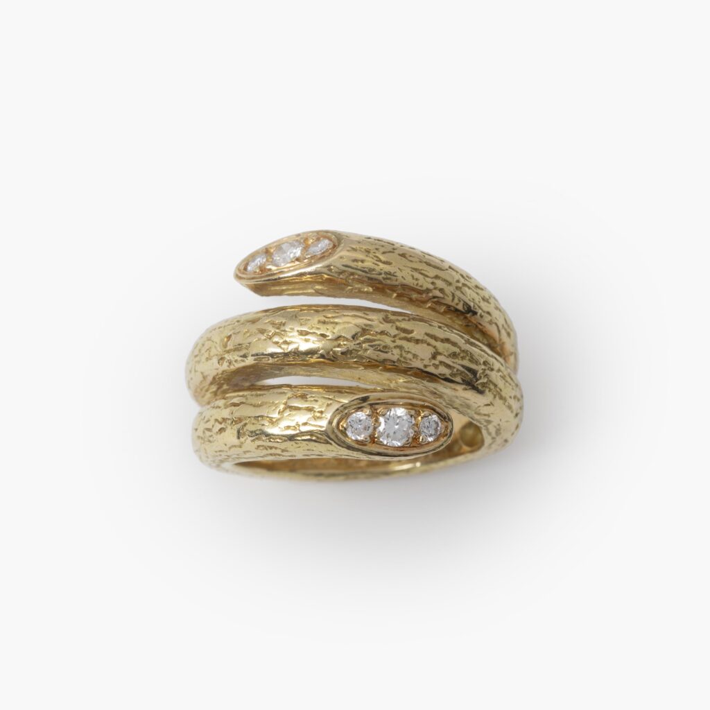 An eighteen carat yellow gold ring designed as two windings, with a textured surface. Signed Van Cleef & Arpels, made in Paris, made ca 1970 and numbered.