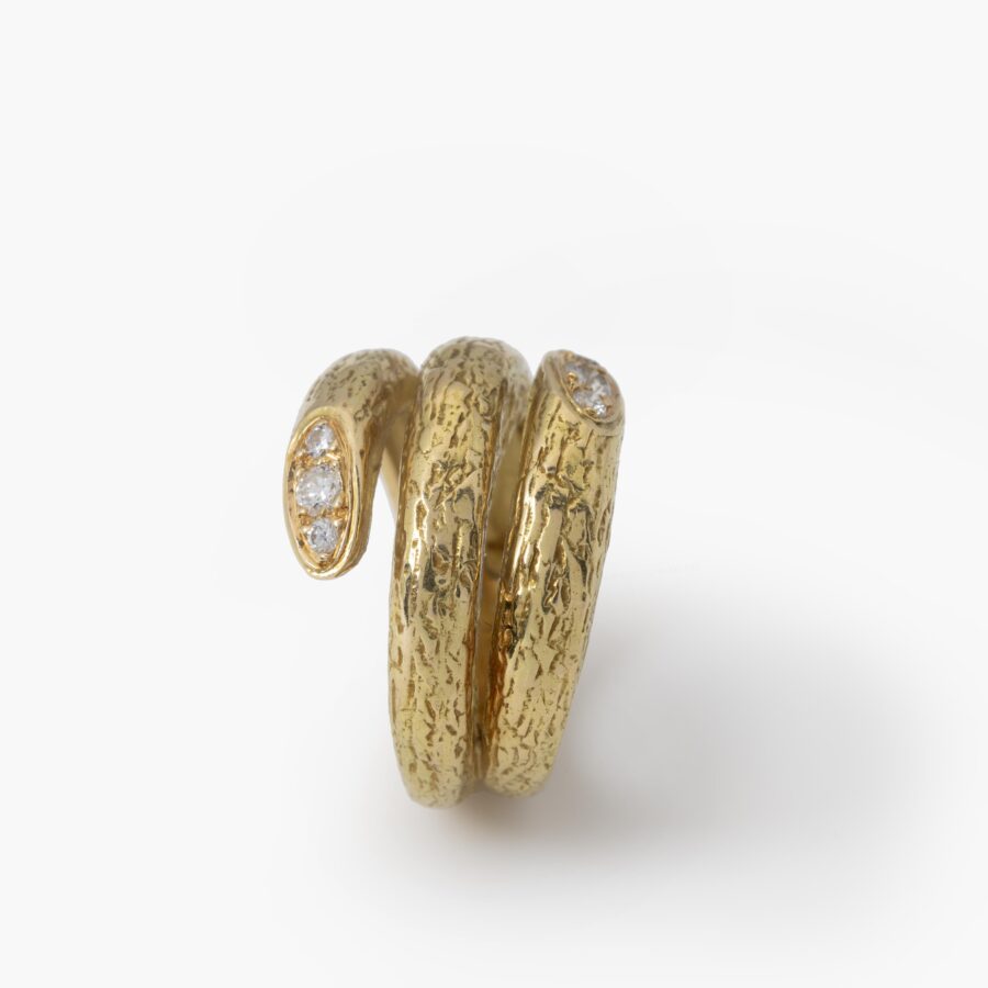 An eighteen carat yellow gold ring designed as two windings, with a textured surface. Signed Van Cleef & Arpels, made in Paris, made ca 1970 and numbered.